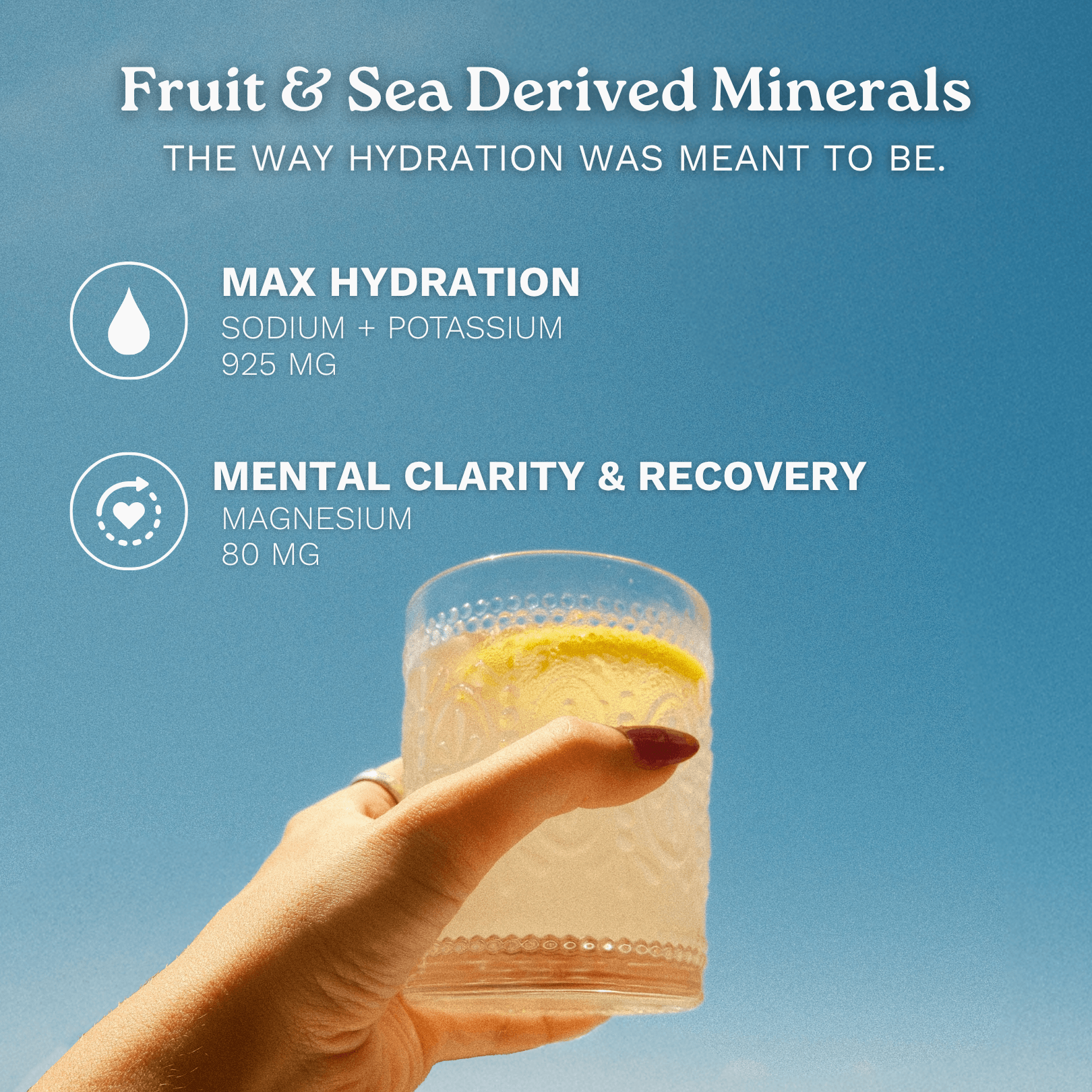 A hand holds a clear textured glass with a pale yellow drink and a lemon slice against a blue sky background. White text at the top reads 'Fruit & Sea Derived Minerals' and lists hydration and mental clarity benefits with ingredient amounts.