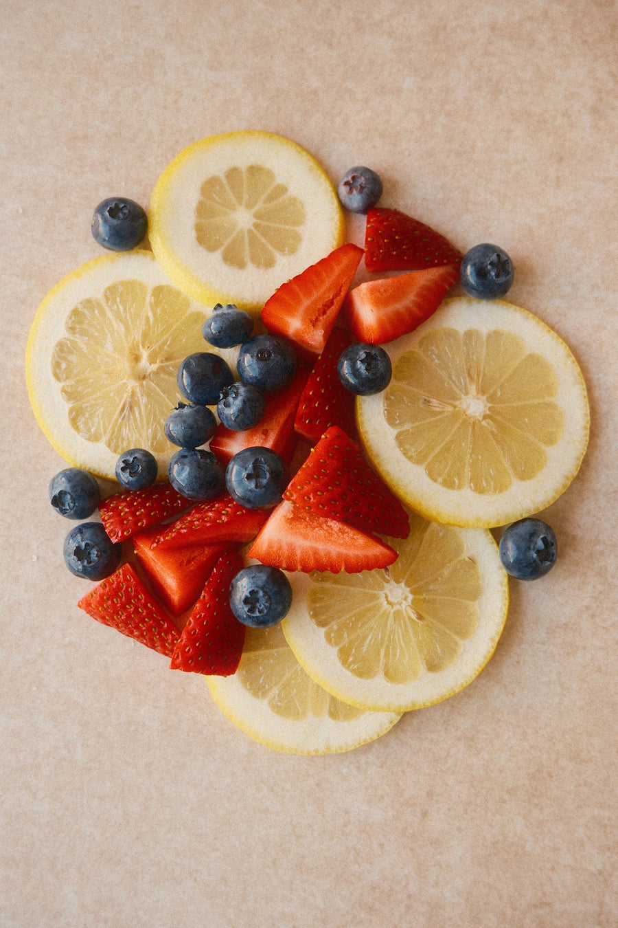 Sliced lemons, strawberries and blueberries