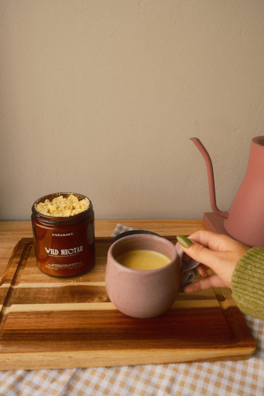 A mug of Wild Nectar next to the jar
